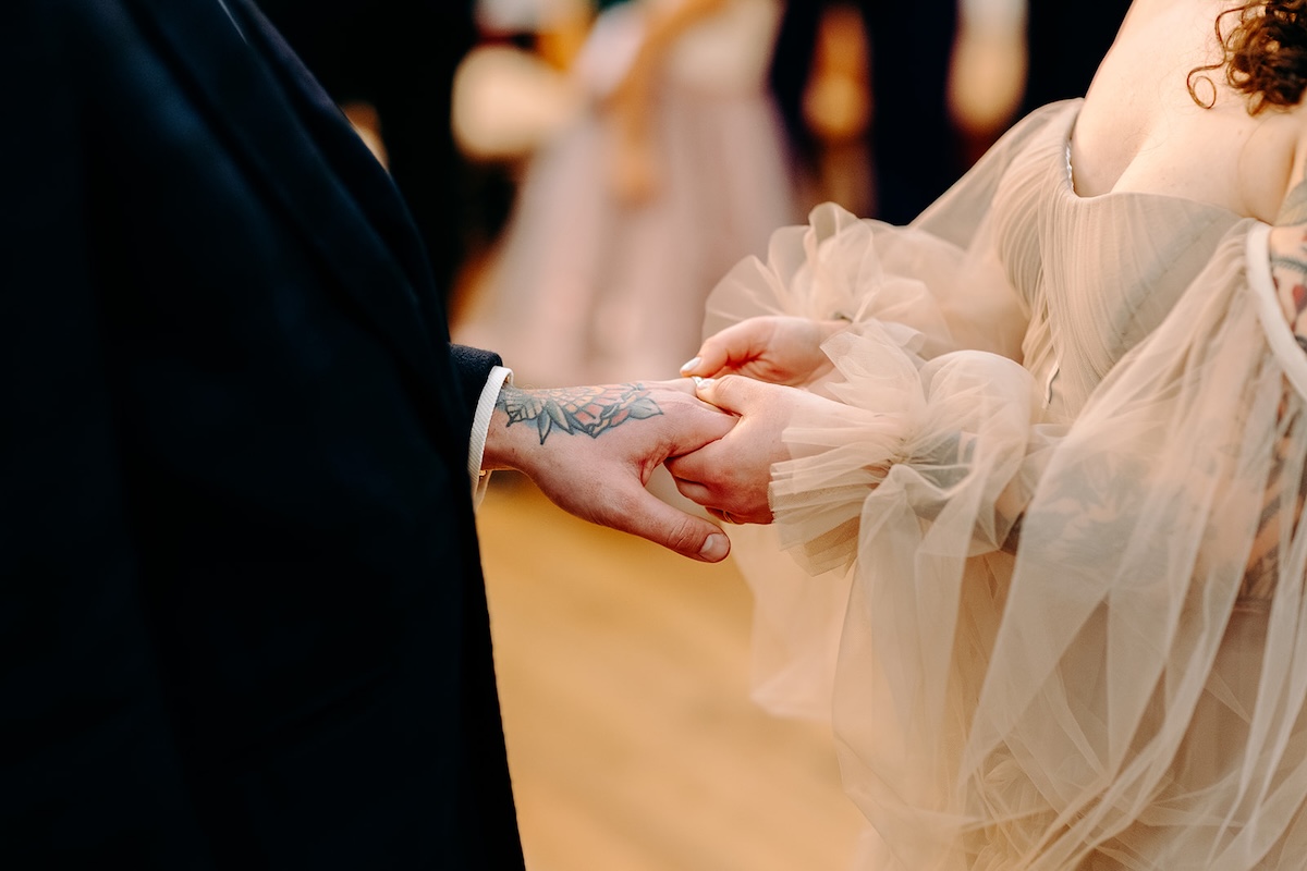 Bride and groom exchanging rings during their winter wedding ceremony at The Wellbeing Farm.