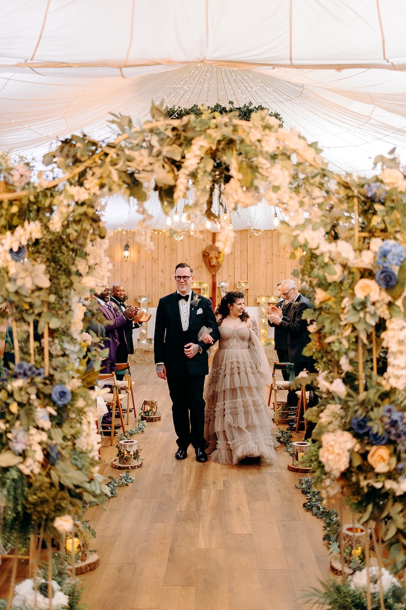 Guests clapping and celebrating after the couple are announced married.