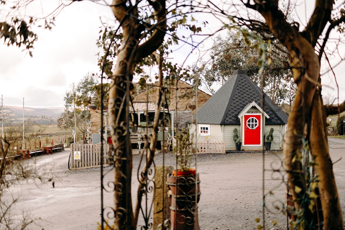 View of the farm entrance and countryside outside The Wellbeing Farm wedding venue on a winter wedding morning, photographed with natural wedding photography.