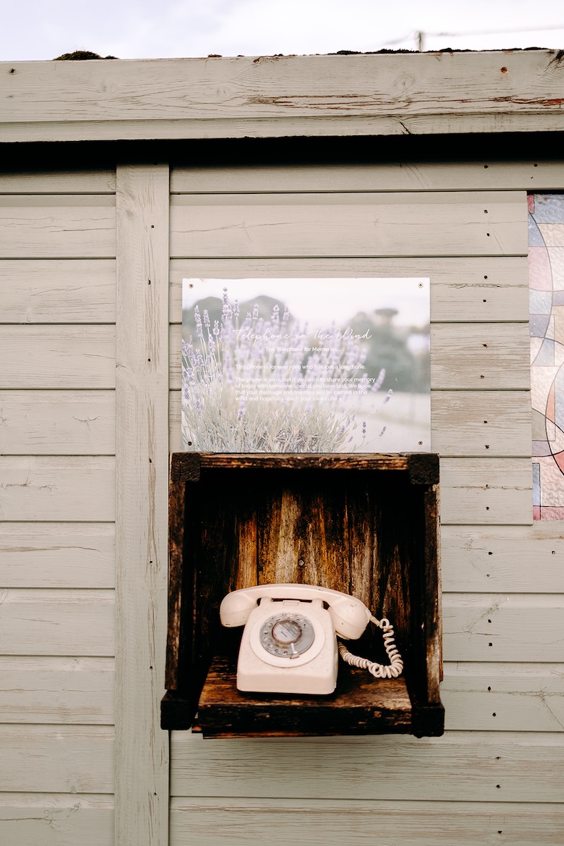 Vintage telephone detail outside the barn at The Wellbeing Farm, a quirky venue feature photographed during a February wedding with documentary wedding photography.