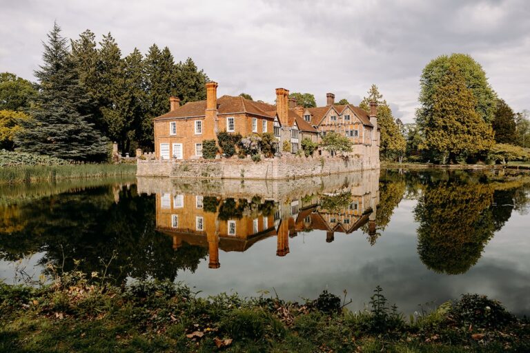 Scenic photograph of Birstmorton Court wedding venue reflected in the water.