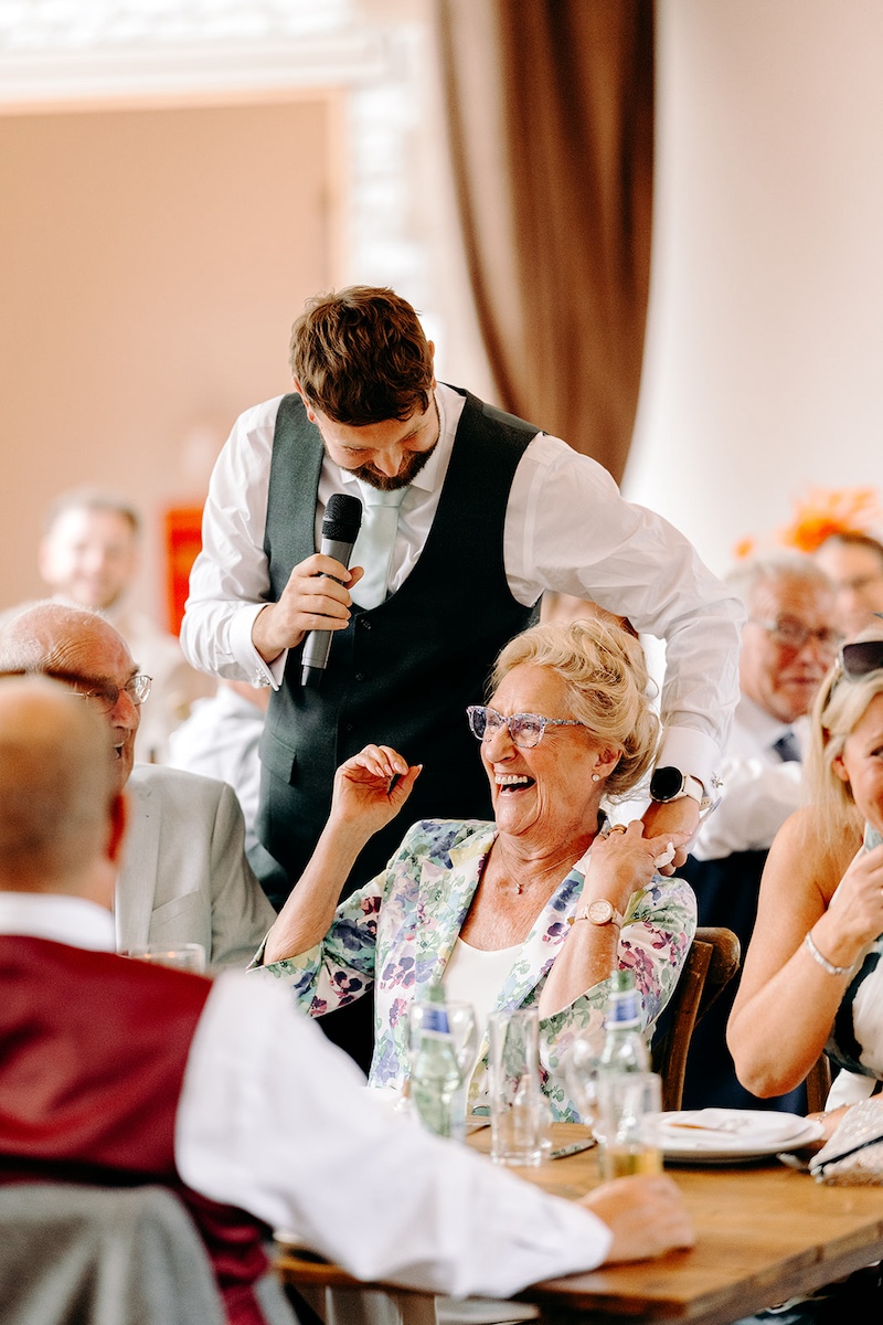 Wedding guests hugging during the relaxed reception celebrations.