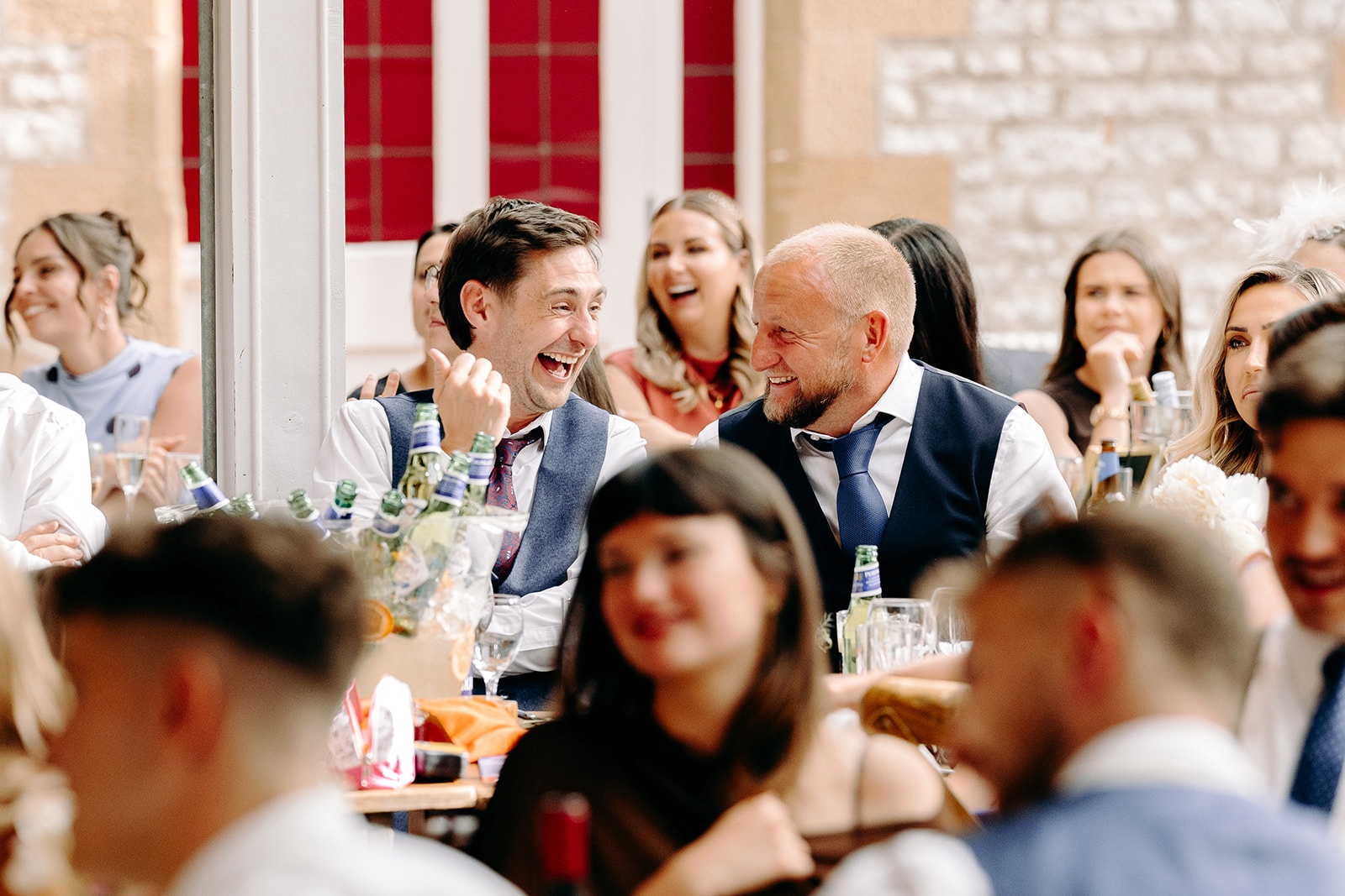 Guests laughing during the speeches at Derbyshire wedding.