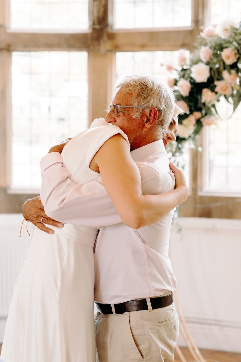 Emotional hug during the wedding speeches at Thornbridge Hall.