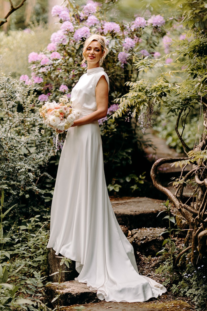 Relaxed bridal portrait surrounded by flowers in the Thornbridge Hall gardens.