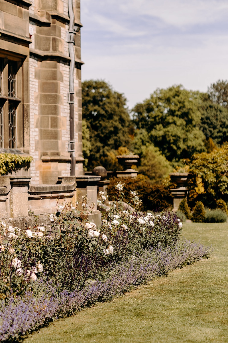 Thornbridge Hall surrounded by summer flowers and lavender in the Derbyshire countryside.
