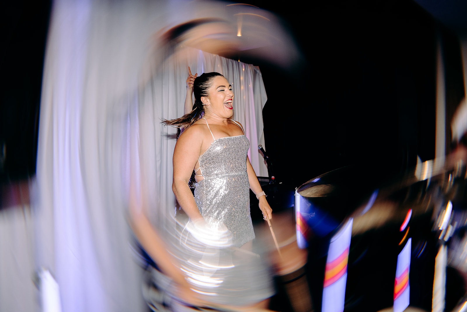 Wedding guest dancing with friends during a fun and colourful evening reception.