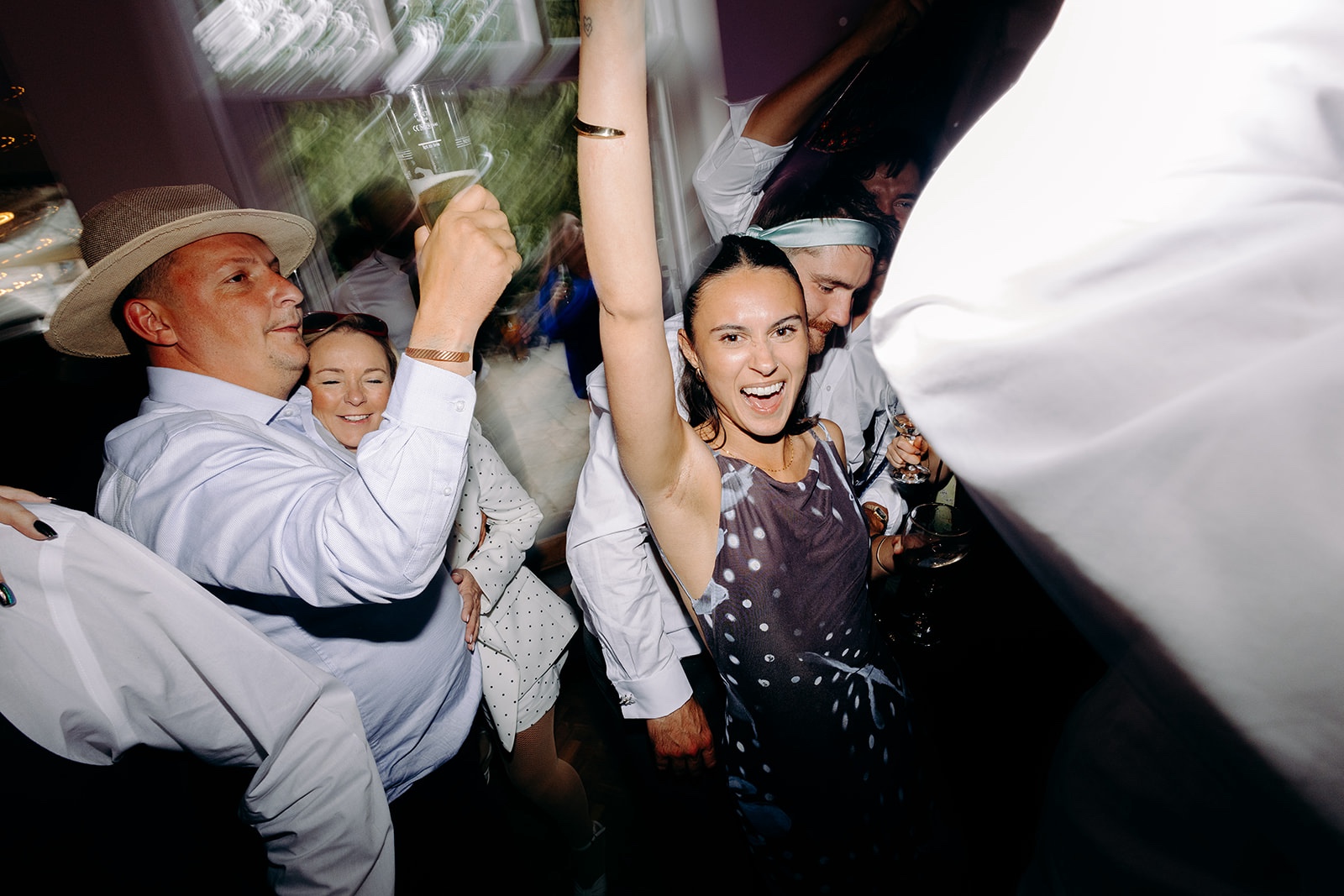 Fun candid moment between wedding guests on the dance floor.