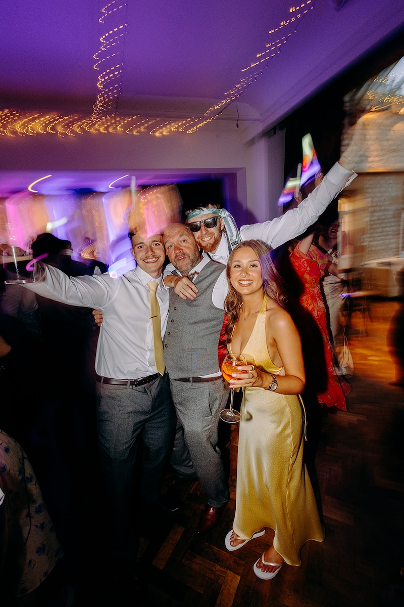 Guests posing together during the colourful late-night wedding celebrations.