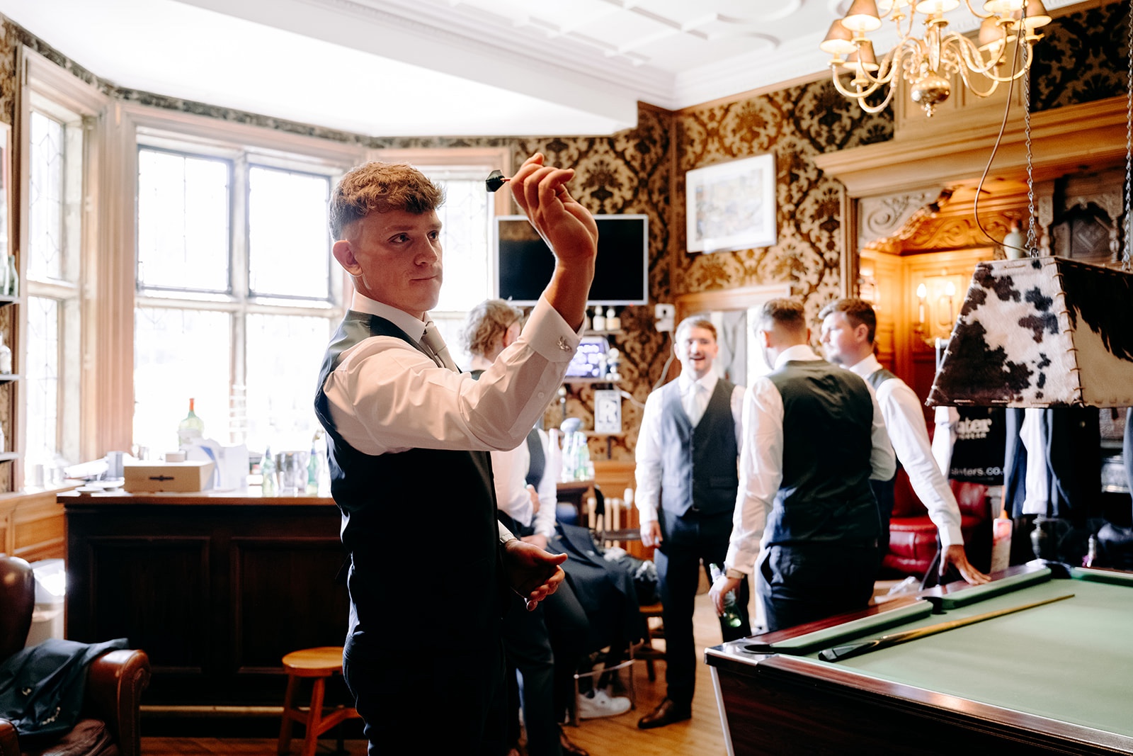 Groom and groomsmen getting ready inside Thornbridge Hall before the wedding ceremony.