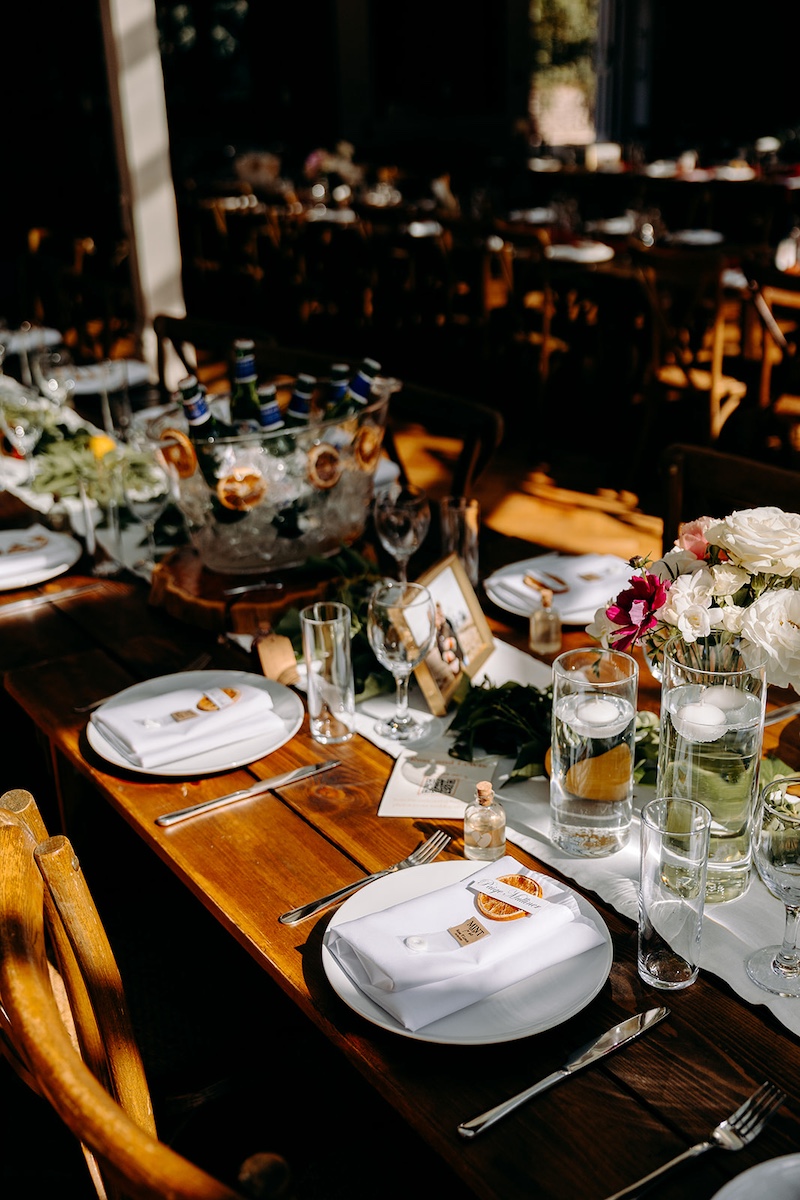 Elegant wedding tables decorated with flowers, lemons and glassware inside The Carriage House.