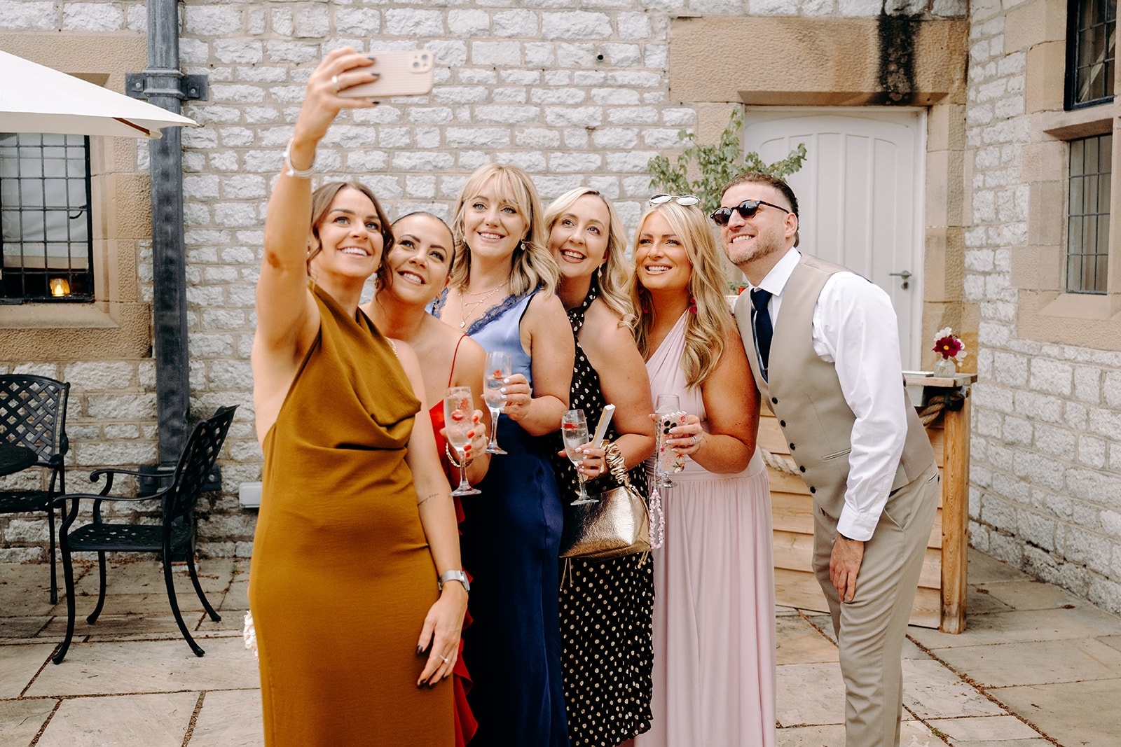 Guests celebrating together outside Thornbridge Hall.