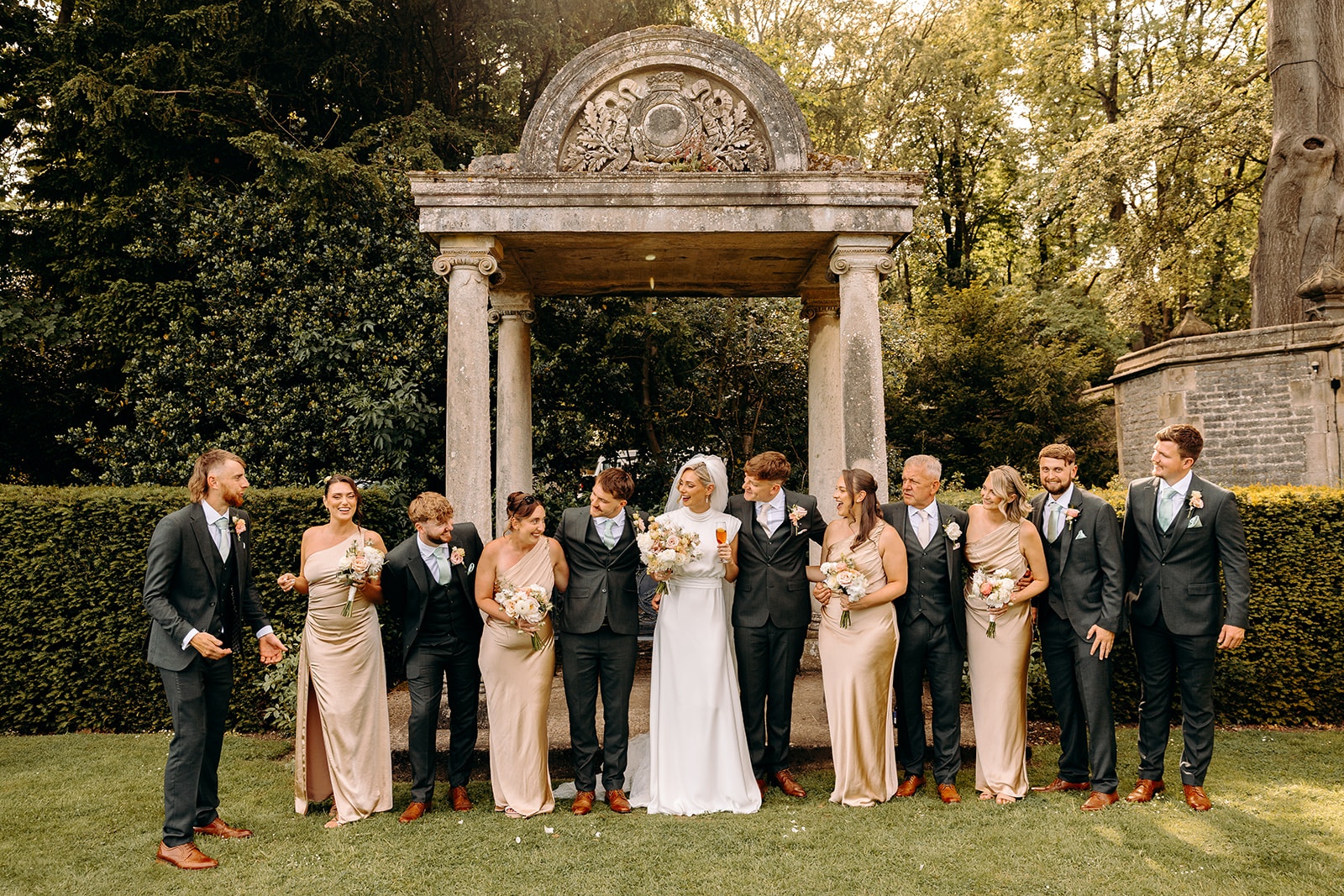 Wedding party group photograph in the gardens at Thornbridge Hall.